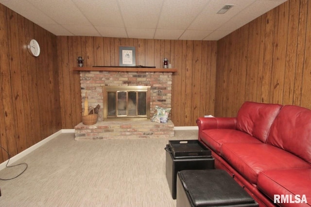 1402 W Grandridge Dr, Dunlap, IL 61525 - living room featuring carpet floors, wood walls, and a brick fireplace