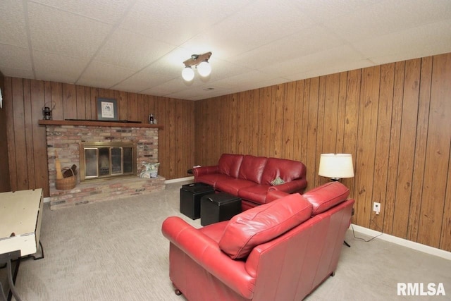 1402 W Grandridge Dr, Dunlap, IL 61525 - living room featuring light colored carpet, wood walls, and a brick fireplace