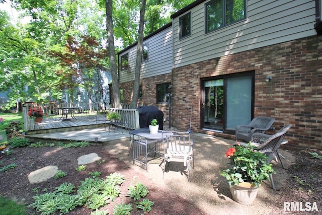 1402 W Grandridge Dr, Dunlap, IL 61525 - view of patio with a wooden deck, grilling area, and outdoor dining space