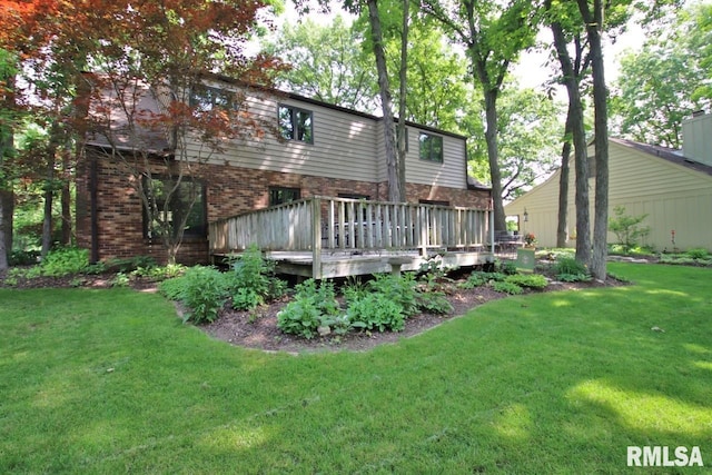 1402 W Grandridge Dr, Dunlap, IL 61525 - back of property with a deck, a lawn, and brick siding
