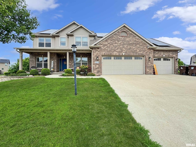 11030 N Ruby Ct, Dunlap, IL 61525 - view of front of home with a front lawn, driveway, solar panels, and brick siding