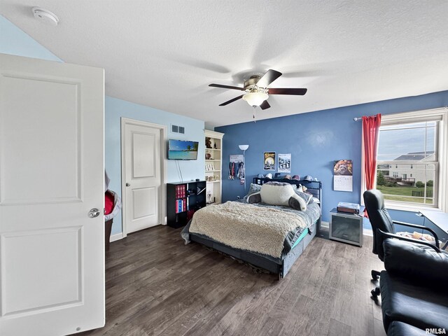 11030 N Ruby Ct, Dunlap, IL 61525 - bedroom featuring wood finished floors, a textured ceiling, an office area, and a ceiling fan