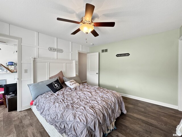 11030 N Ruby Ct, Dunlap, IL 61525 - bedroom featuring dark wood-type flooring, a textured ceiling, and ceiling fan