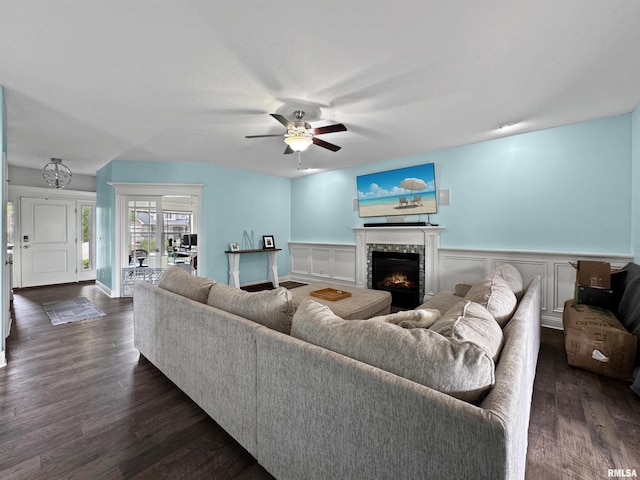 11030 N Ruby Ct, Dunlap, IL 61525 - living area with dark wood finished floors, a ceiling fan, a lit fireplace, a wainscoted wall, and a decorative wall