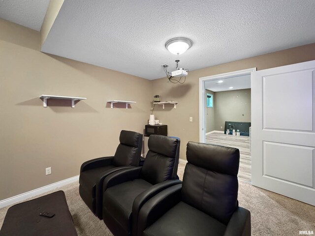 11030 N Ruby Ct, Dunlap, IL 61525 - carpeted cinema room featuring a textured ceiling and baseboards