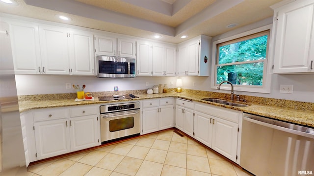 1119 W Brookforest Dr, Peoria, IL 61615 - kitchen featuring stainless steel appliances, recessed lighting, white cabinetry, light tile patterned floors, and light stone counters