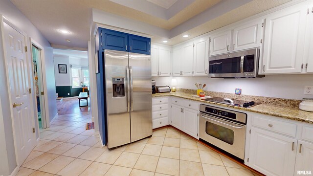 1119 W Brookforest Dr, Peoria, IL 61615 - kitchen featuring appliances with stainless steel finishes, recessed lighting, light tile patterned flooring, white cabinets, and light stone countertops