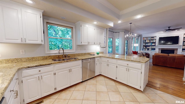 1119 W Brookforest Dr, Peoria, IL 61615 - kitchen with dishwasher, a brick fireplace, a peninsula, open floor plan, and ceiling fan