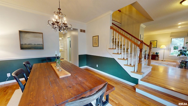 1119 W Brookforest Dr, Peoria, IL 61615 - dining room with ornamental molding, stairway, wood finished floors, and a chandelier