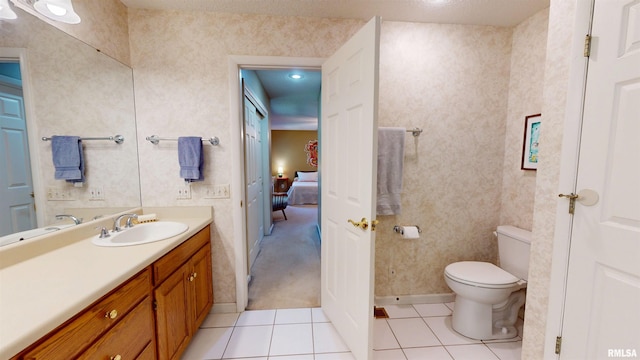 1119 W Brookforest Dr, Peoria, IL 61615 - bathroom with tile patterned floors, vanity, and ensuite bath