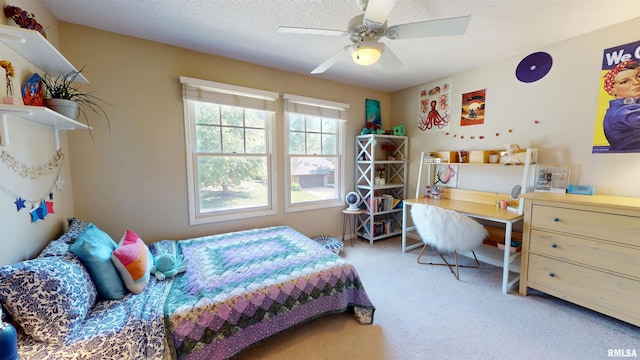 1119 W Brookforest Dr, Peoria, IL 61615 - bedroom with carpet flooring, ceiling fan, a desk, and a textured ceiling