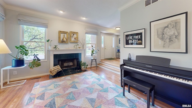 1119 W Brookforest Dr, Peoria, IL 61615 - living area featuring crown molding, wood finished floors, and a tiled fireplace