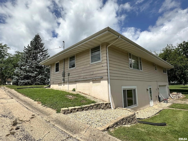 2401 Springfield Rd, East Peoria, IL 61611 - view of home's exterior featuring a garage and a lawn