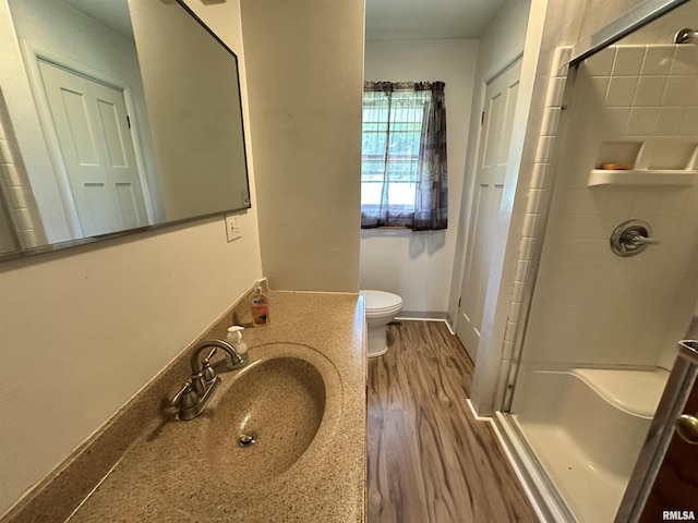 2401 Springfield Rd, East Peoria, IL 61611 - bathroom featuring a shower stall, wood finished floors, and vanity