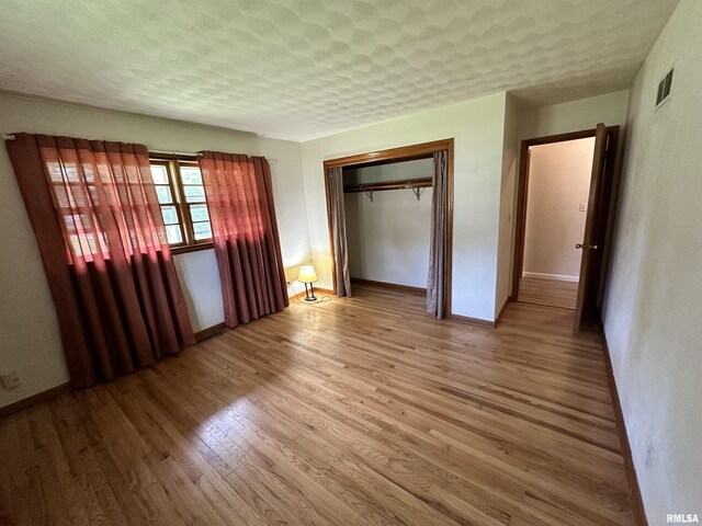 2401 Springfield Rd, East Peoria, IL 61611 - unfurnished bedroom with wood finished floors and a closet