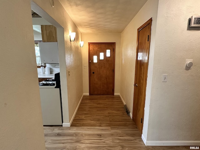 2401 Springfield Rd, East Peoria, IL 61611 - corridor featuring wood finished floors and a textured wall