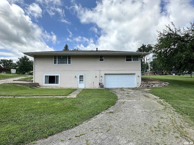 2401 Springfield Rd, East Peoria, IL 61611 - back of house with driveway, a garage, and a lawn