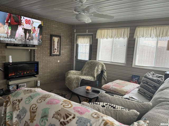 1104 S 8th St, Pekin, IL 61554 - living room with brick wall, a ceiling fan, and a fireplace