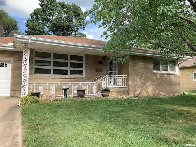 1104 S 8th St, Pekin, IL 61554 - single story home with brick siding, a front yard, and an attached garage