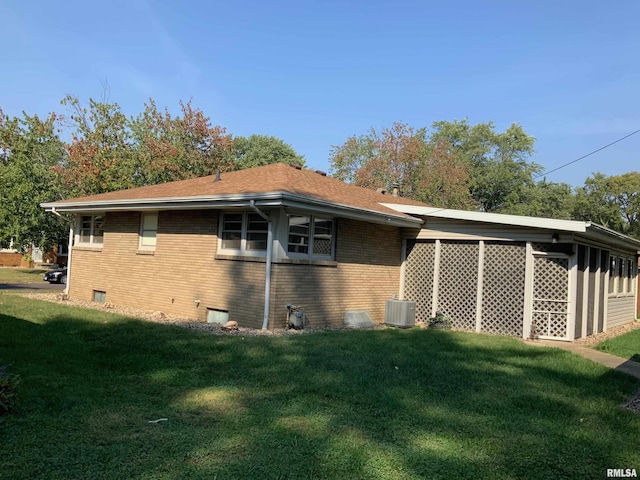 1104 S 8th St, Pekin, IL 61554 - view of side of home with brick siding, a lawn, and a shingled roof