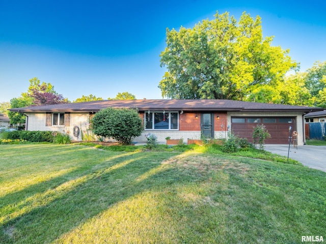 5004 N Dawn Dr, Peoria, IL 61614 - ranch-style house with brick siding, an attached garage, driveway, and a front yard