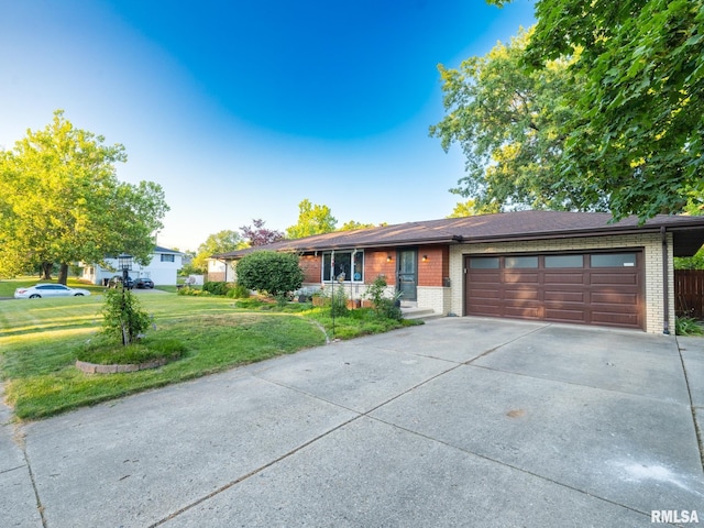 5004 N Dawn Dr, Peoria, IL 61614 - view of front facade with brick siding, concrete driveway, a front yard, and an attached garage