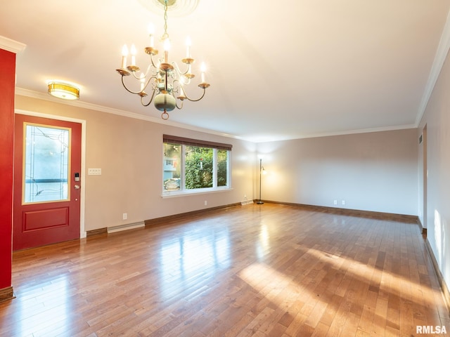 5004 N Dawn Dr, Peoria, IL 61614 - unfurnished living room featuring a chandelier, wood finished floors, ornamental molding, and baseboard heating