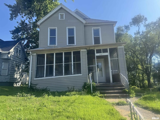 512 Fairholm Ave, Peoria, IL 61603 - traditional-style home with a sunroom and a front lawn