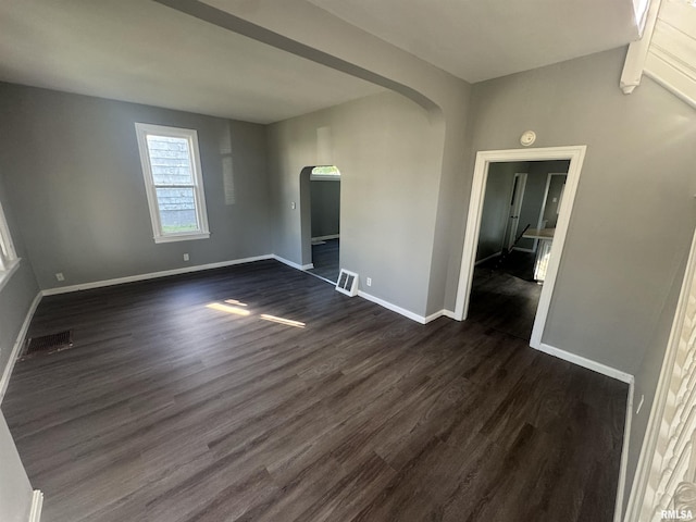 512 Fairholm Ave, Peoria, IL 61603 - unfurnished room with arched walkways and dark wood finished floors