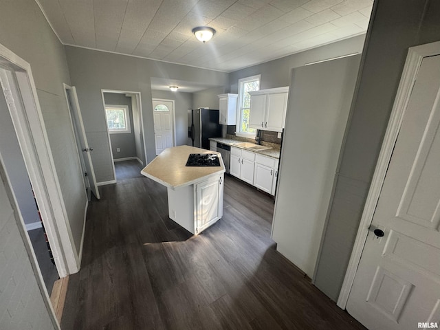512 Fairholm Ave, Peoria, IL 61603 - kitchen with fridge with ice dispenser, stainless steel dishwasher, white cabinetry, a kitchen island, and dark wood-style floors