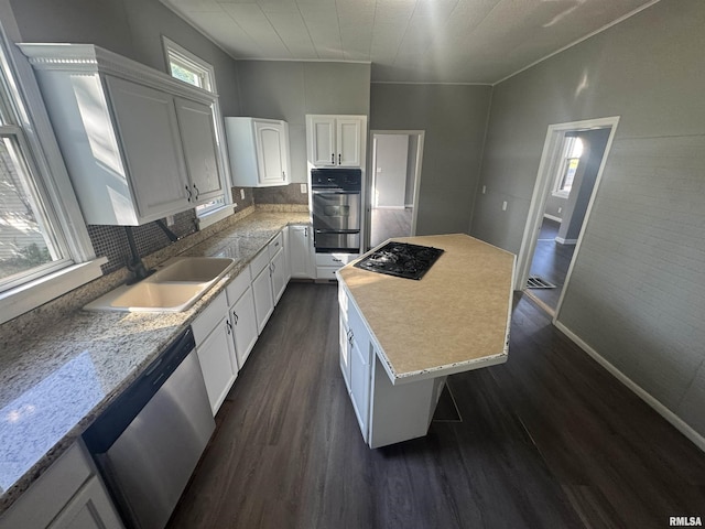 512 Fairholm Ave, Peoria, IL 61603 - kitchen with oven, dark wood-type flooring, black gas stovetop, stainless steel dishwasher, and a warming drawer