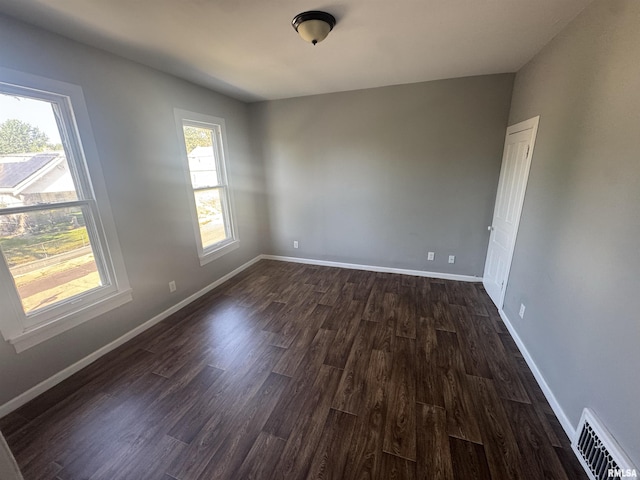 512 Fairholm Ave, Peoria, IL 61603 - empty room with dark wood-style floors and baseboards