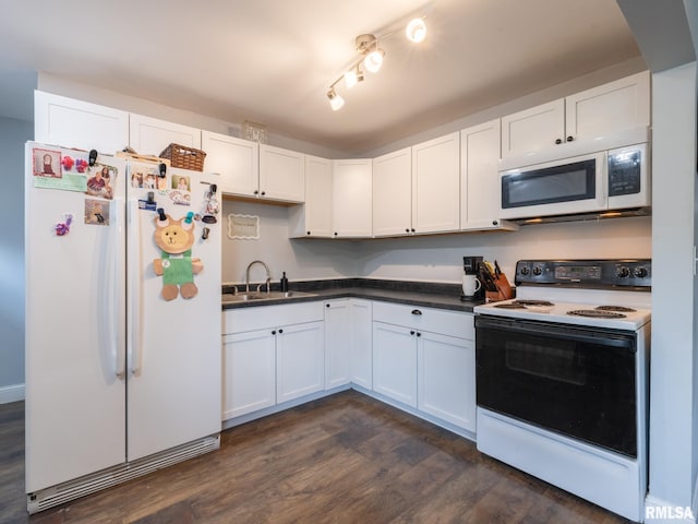 1600 W Willcox Ave, Peoria, IL 61604 - kitchen with white appliances, dark wood-type flooring, white cabinets, and dark countertops