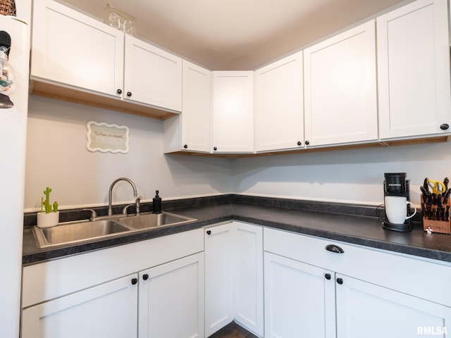 1600 W Willcox Ave, Peoria, IL 61604 - kitchen with white cabinetry and dark countertops