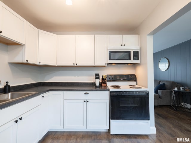 1600 W Willcox Ave, Peoria, IL 61604 - kitchen with white appliances, white cabinetry, dark countertops, and dark wood-style floors