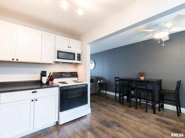 1600 W Willcox Ave, Peoria, IL 61604 - kitchen featuring white appliances, dark countertops, dark wood finished floors, white cabinetry, and ceiling fan