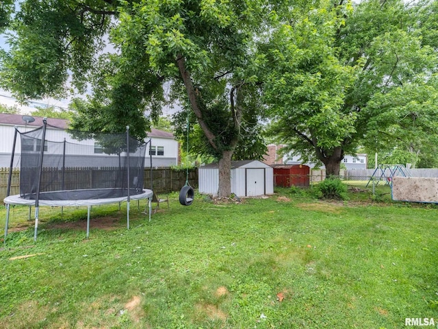 1600 W Willcox Ave, Peoria, IL 61604 - fenced backyard featuring a trampoline and a storage unit