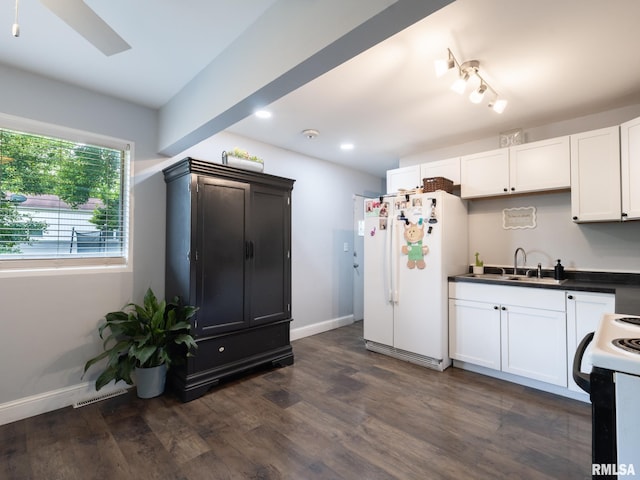 1600 W Willcox Ave, Peoria, IL 61604 - kitchen featuring white appliances, dark wood-style floors, dark countertops, white cabinets, and recessed lighting