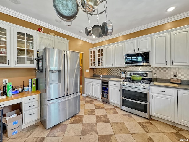 11801 N Deerfield Dr, Dunlap, IL 61525 - kitchen featuring appliances with stainless steel finishes, wine cooler, backsplash, glass insert cabinets, and ornamental molding