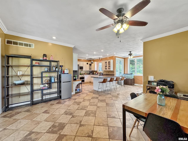 11801 N Deerfield Dr, Dunlap, IL 61525 - dining space featuring crown molding, ceiling fan, and recessed lighting