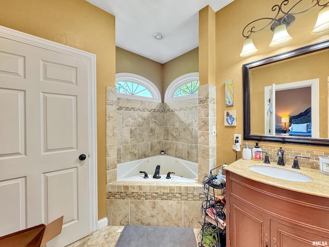 11801 N Deerfield Dr, Dunlap, IL 61525 - ensuite bathroom featuring a garden tub, vanity, lofted ceiling, and tasteful backsplash