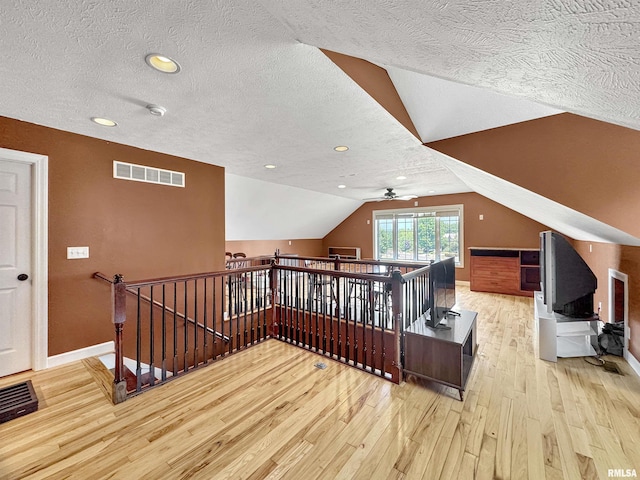 11801 N Deerfield Dr, Dunlap, IL 61525 - additional living space featuring hardwood / wood-style flooring, a textured ceiling, vaulted ceiling, and a ceiling fan