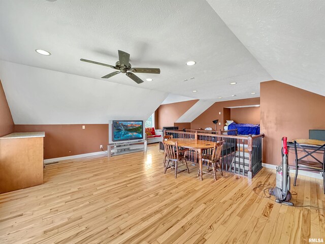 11801 N Deerfield Dr, Dunlap, IL 61525 - rec room with wood finished floors, vaulted ceiling, ceiling fan, and a textured ceiling