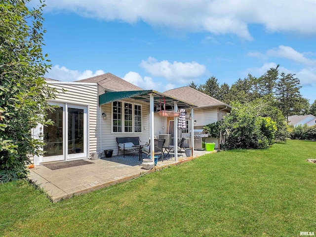 11801 N Deerfield Dr, Dunlap, IL 61525 - rear view of property with a patio, a yard, and a shingled roof