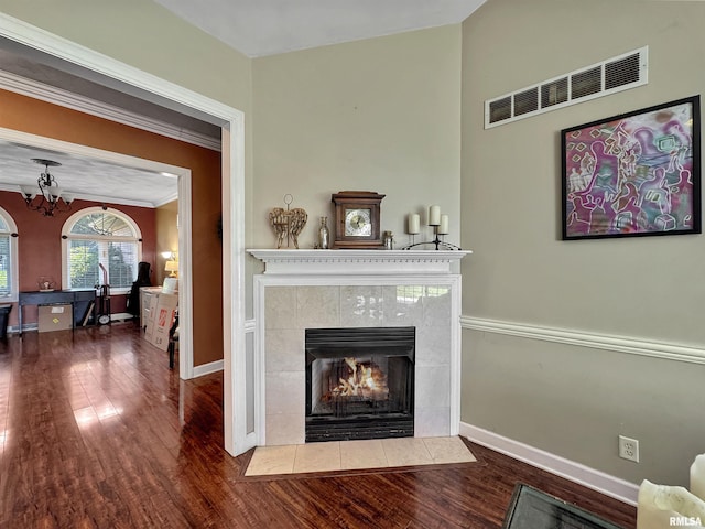 11801 N Deerfield Dr, Dunlap, IL 61525 - living room with wood finished floors, a tiled fireplace, crown molding, and a chandelier