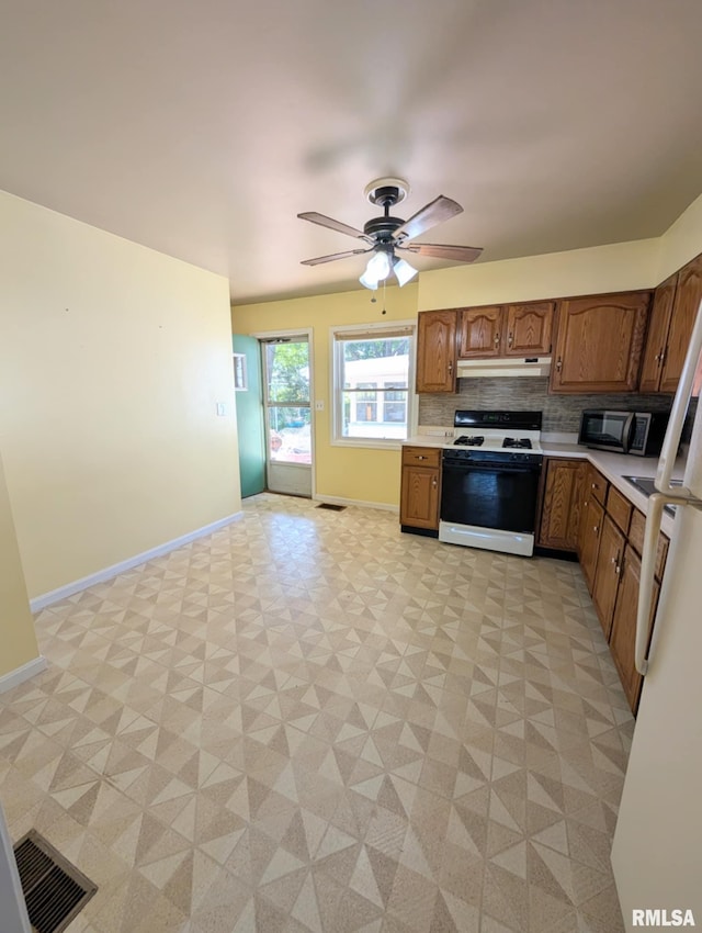 1427 Matilda St, Pekin, IL 61554 - kitchen featuring white appliances, light countertops, under cabinet range hood, and tasteful backsplash