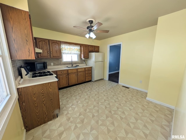 1427 Matilda St, Pekin, IL 61554 - kitchen with freestanding refrigerator, light countertops, light floors, ceiling fan, and black microwave