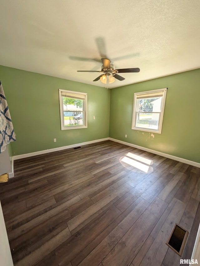 1427 Matilda St, Pekin, IL 61554 - unfurnished room with plenty of natural light, a ceiling fan, and dark wood-style floors