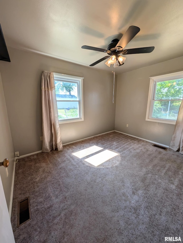 1427 Matilda St, Pekin, IL 61554 - empty room with healthy amount of natural light, ceiling fan, and carpet