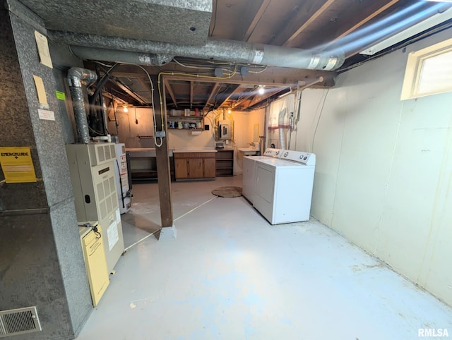1427 Matilda St, Pekin, IL 61554 - below grade area featuring washer and dryer, electric panel, and water heater
